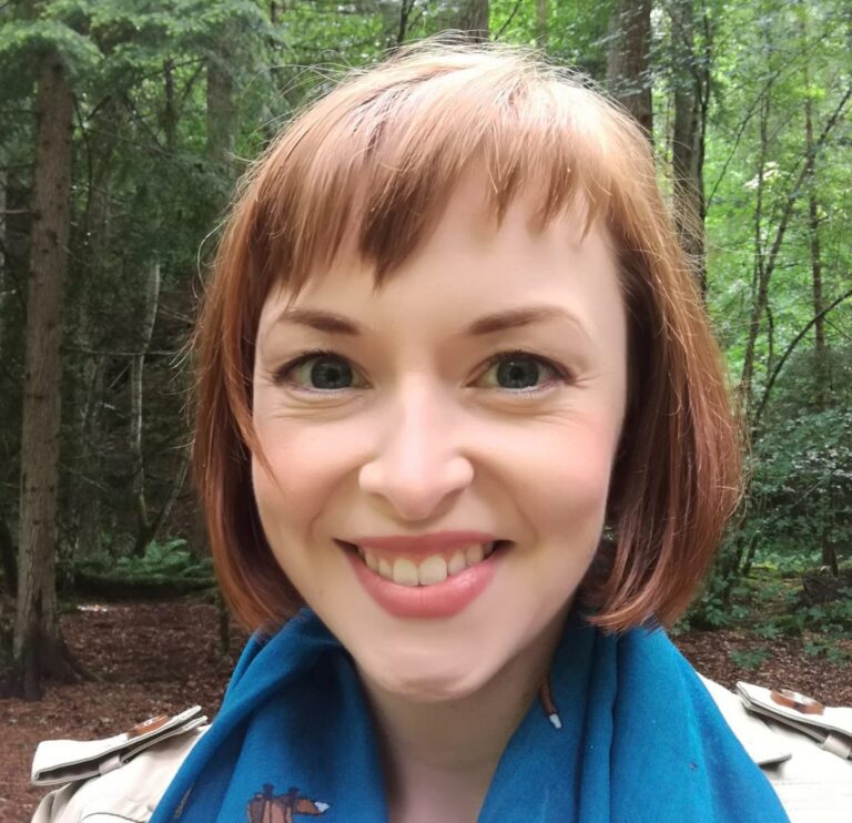 Picture: A headshot of Lauren Stewart with woods in the background