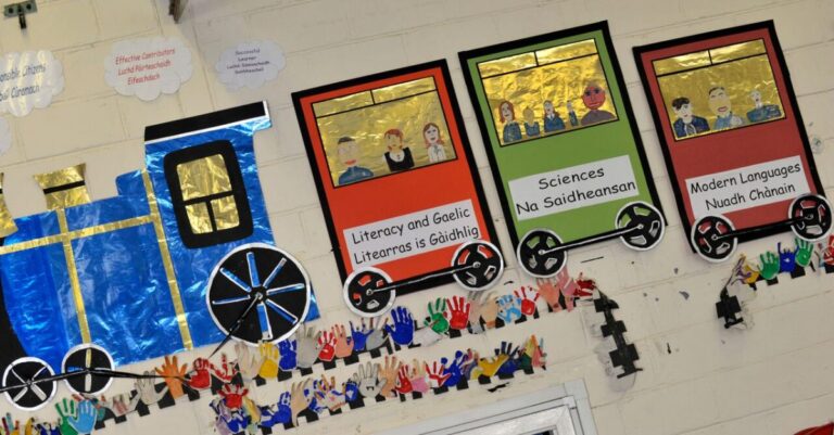 Picture: The wall of a classroom with a train on the wall naming different school subjects in Gaelic and English