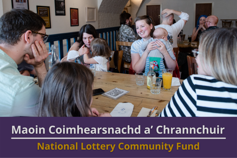 Picture: A group of people of all ages at a Gelic meet-up in a busy Cafe. Text reads 'National Lottery Community Fund'.