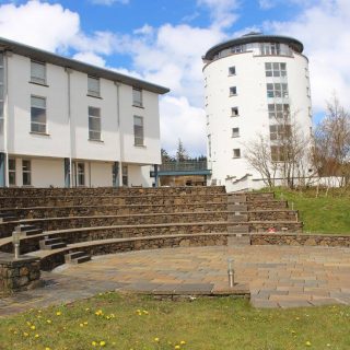 Picture: Sabhal Mòr Ostaig's Àrainn Chaluim Chille and Tower buildings as well as the outdoor amphitheater at the front of the buildings.