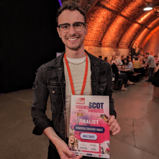 Picture: Mark Smith holding his finalist's certificate at the 2023 Young Scot Awards.