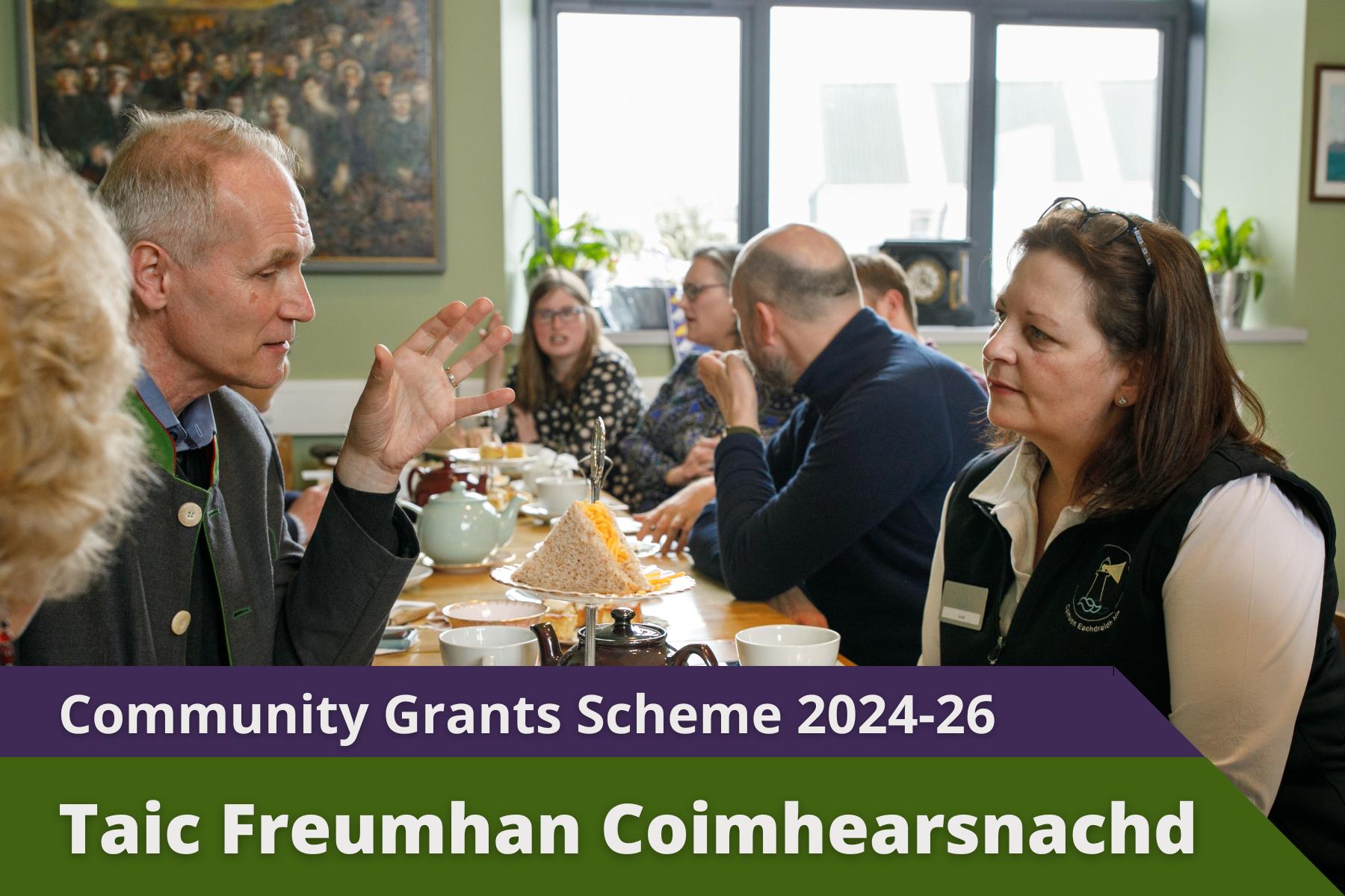 Picture: Afternoon tea with many people sat around table, man and woman talking in foreground with text over picture. Text reads 'Community Grants Scheme 2024-26'