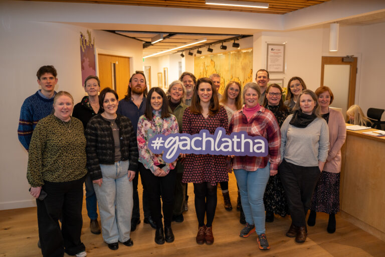 Picture: A group of Gaelic officers standing together and holding a large sign that reads "#gachlatha".